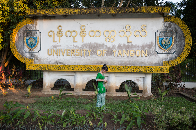 a woman standing by sign