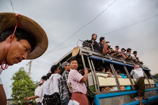 People crowd on the local bus in Dala, Burma. Lack of transportation infrastructure is a tremendous obstacle for economic development in the country. Photo credit: © Ed Kashi/VII for the Open Society Foundations People riding a bus