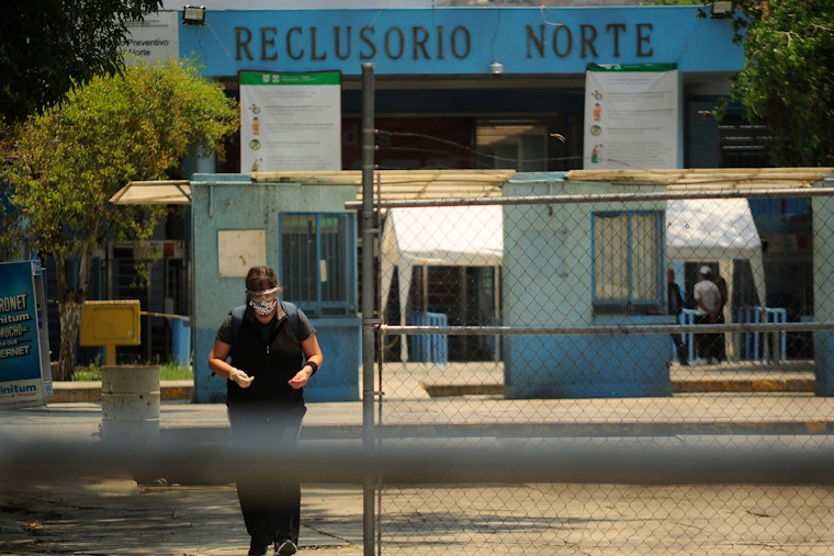 A woman walking away from a prison