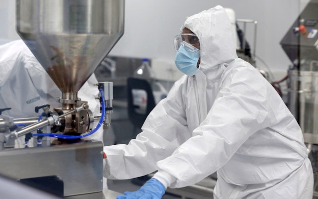 A scientist wearing protective gear in a lab