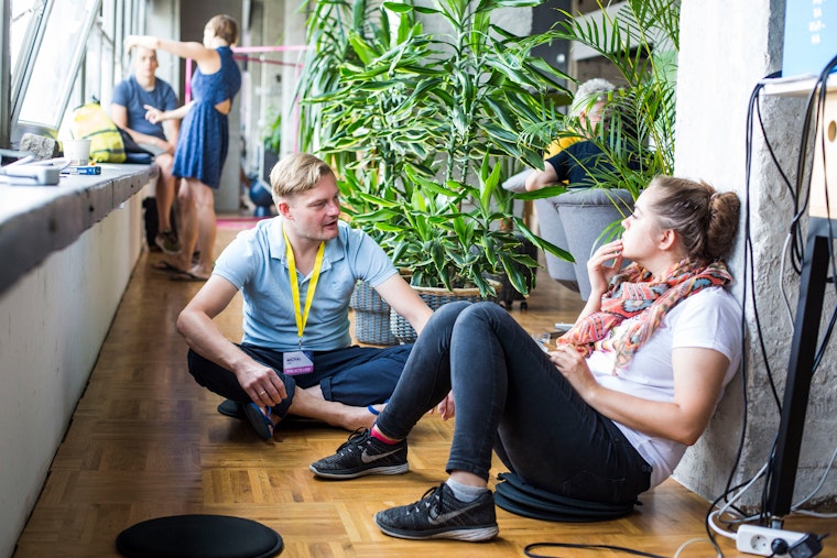 The winning team at Fine Acts Labs CEE, an event bridging human rights, art, and technology in Sofia, Bulgaria, on June 9, 2018. Photo credit: Radina Gancheva for Fine Acts Two people sitting on the floor