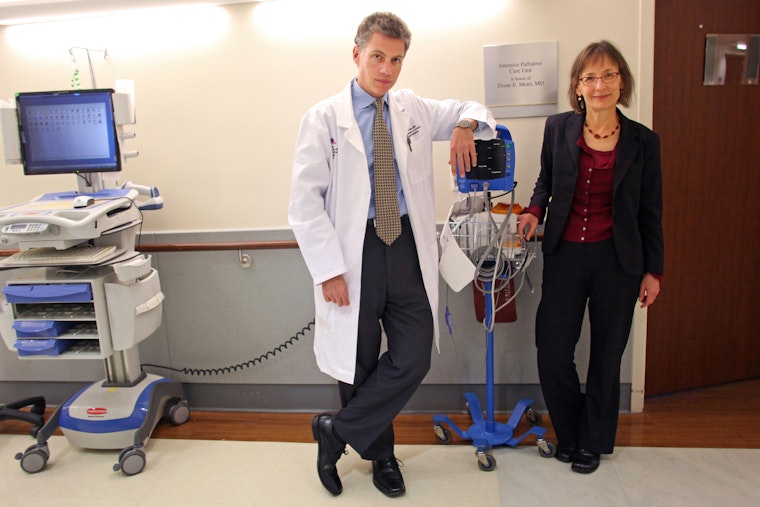 Dr. R. Sean Morrison and Dr. Diane Meier at Mount Sinai Intensive Palliative Care Unit in New York City, on November 12, 2013. ©Yana Paskova/NYTimes/Redux A male and a female doctor stand next to one another next to medical equipment.