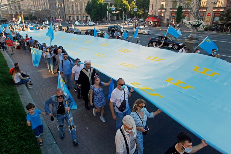 People carry giant Crimean Tatar flag