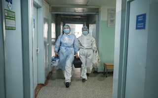 Two doctors walking in a hallway