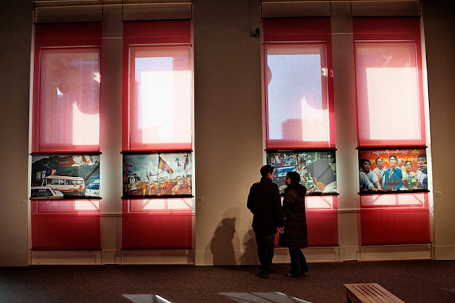 Two people looking at images at exhibit