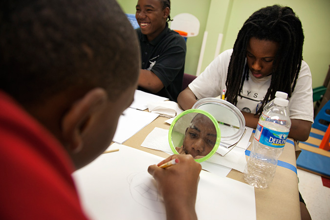 Kids drawing self-portraits