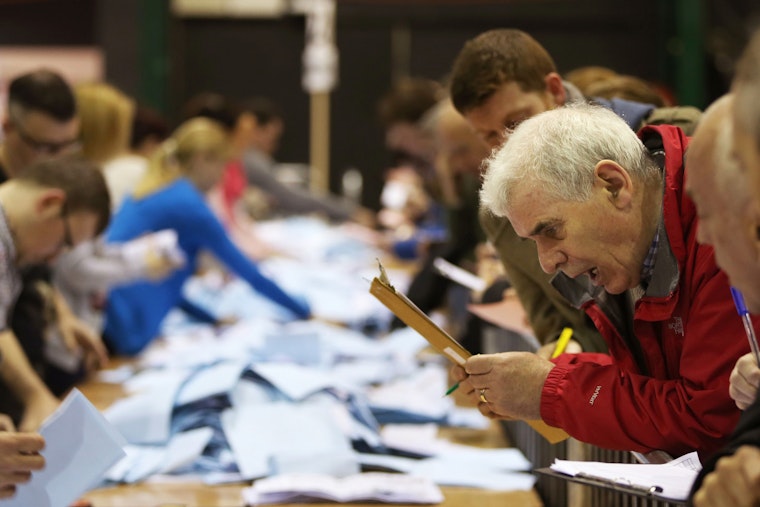 Ballot boxes are opened as counting begins for the local and European Parliamentary elections on May 24, 2014, in Dublin, Ireland. Photo credit: © Niall Carson/PA/Getty A man looking at a clipboard