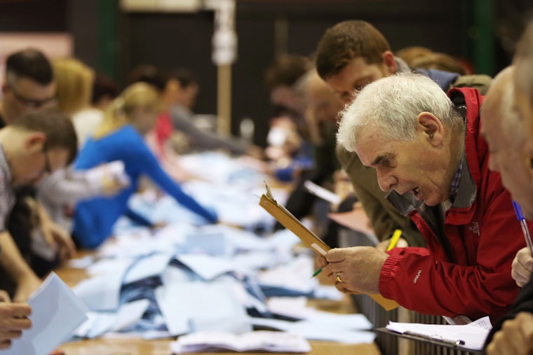 A man looking at a clipboard