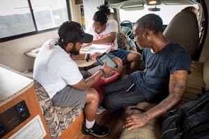 Three people in a mobile clinic