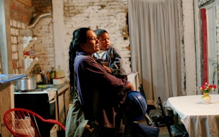 A mother holds her daughter as she prepares to take her to day care, in Argentina, on April 15, 2009. Photo credit: © Marta Nascimento/REA/Redux A woman holding her daughter
