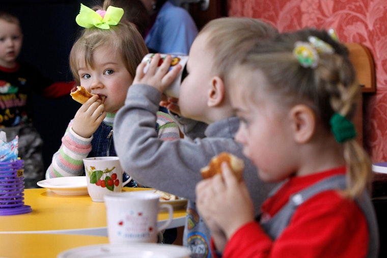 Kindergarteners have lunch at school in the southwestern village of Khatsky, Ukraine, on February 10, 2012. Photo credit: © Gleb Garanich/Newscom Children eating and drinking