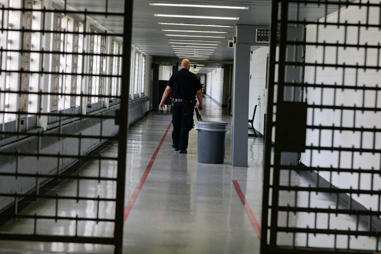 A man walking in a corridor. 