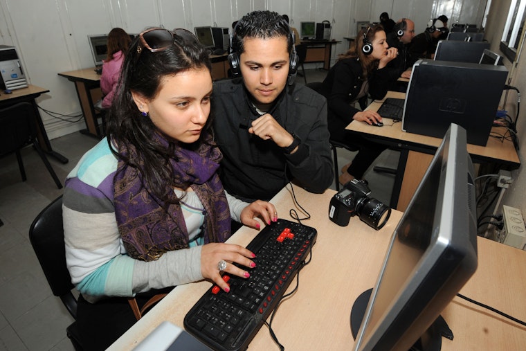 Young students use Facebook in an internet center in Tunis on March 13, 2012, the first National Day for Internet Freedom. Photo credit: © Fethi Belaid/AFP/Getty Two people at a computer