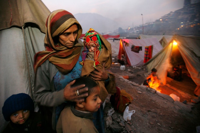 A woman with several children among tents