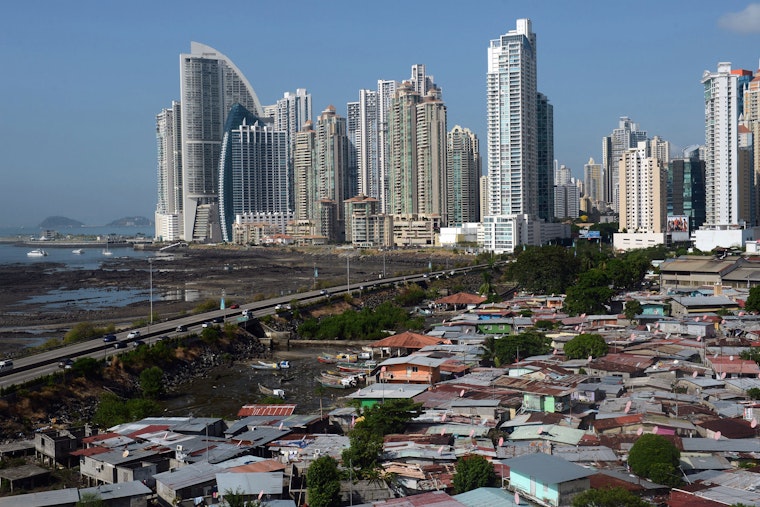 Panama City's skyline behind multiple makeshift homes.