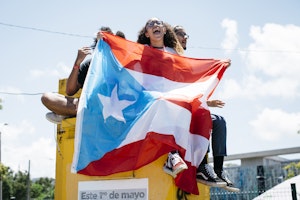 Students holding a Puerto Rican flag