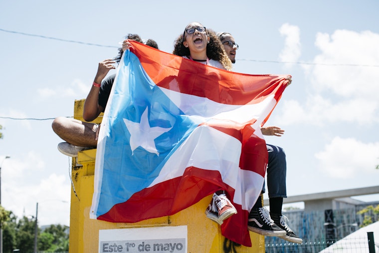 Students protest in front of a University of Puerto Rico building in San Juan, Puerto Rico, on May 11, 2017. Photo credit: © Erika P. Rodriguez Students holding a Puerto Rican flag