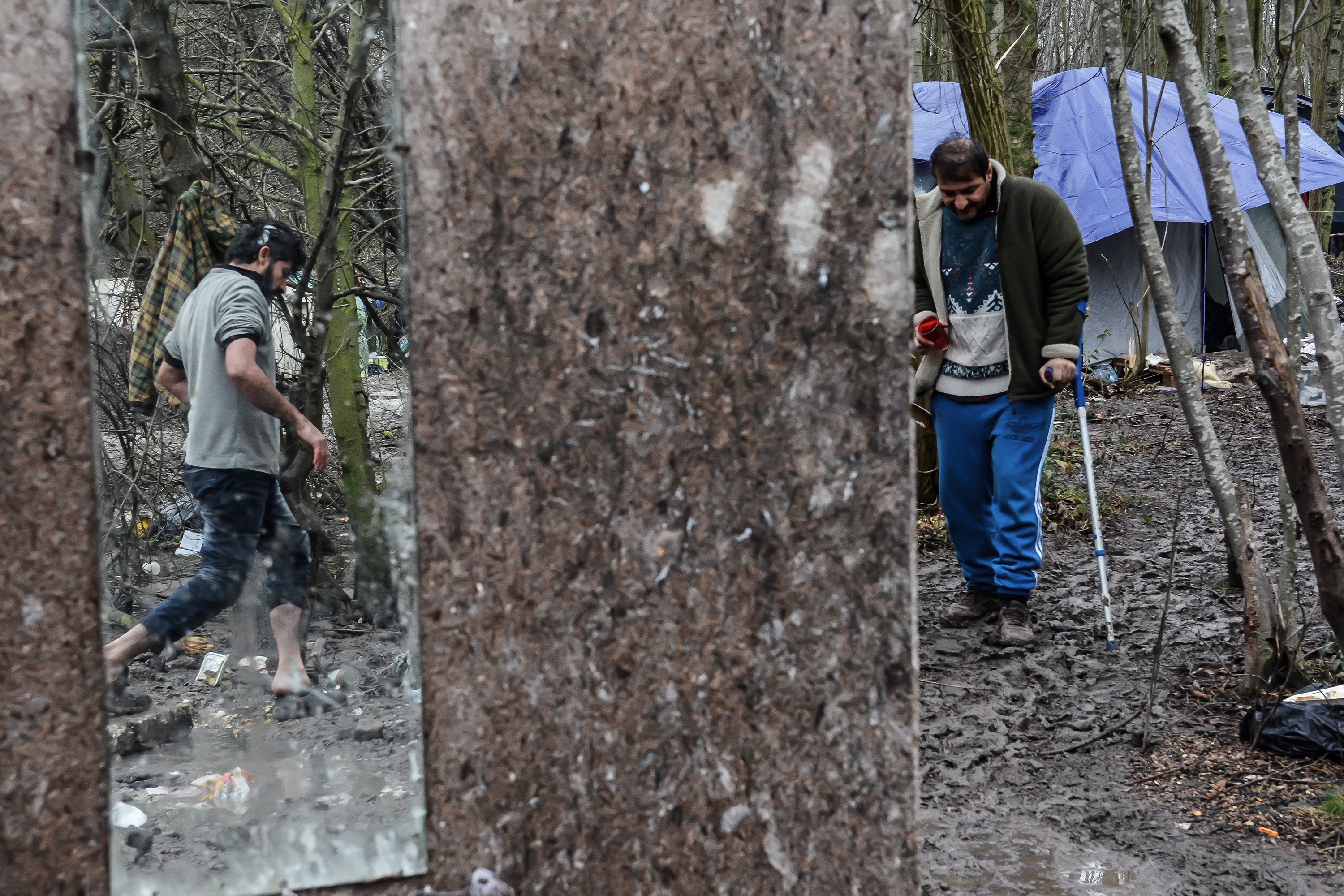 Men walking through mud in a wooded area