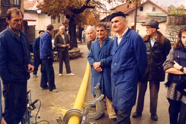 A team of workers cutting pipes