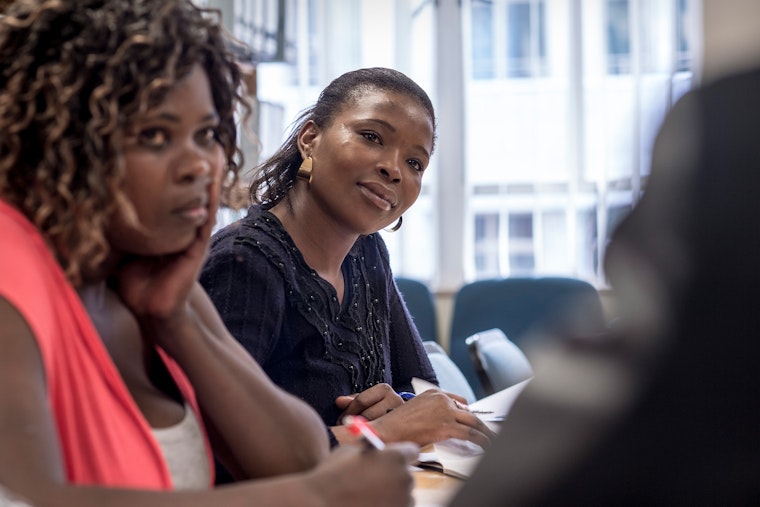 Paralegals with the Sex Workers Education and Advocacy Taskforce (SWEAT) provide legal advice and counseling to sex workers during a weekly meeting at the Women’s Legal Center in Cape Town, South Africa. Photo credit: © Sven Torfinn/ Panos Pictures for Open Society Foundations Women at a desk in a meeting room