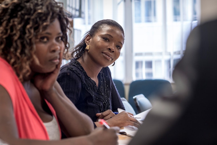 Women at a desk in a meeting room