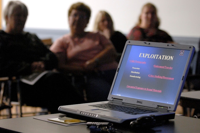 Parents listen to a seminar on teens and “sexting,” a practice that has led to charges of child pornography and landed juveniles on the sex offender registry. Photo credit: © Jessica Hill/AP Parents sit during a presentation