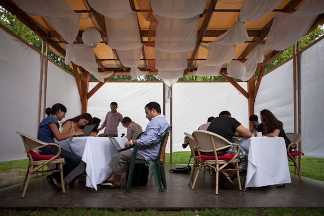 Barvalipe participants sitting at tables.