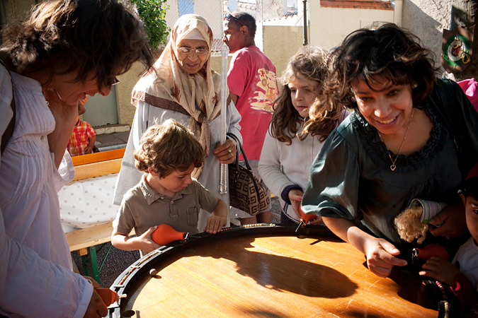 People standing around large drum