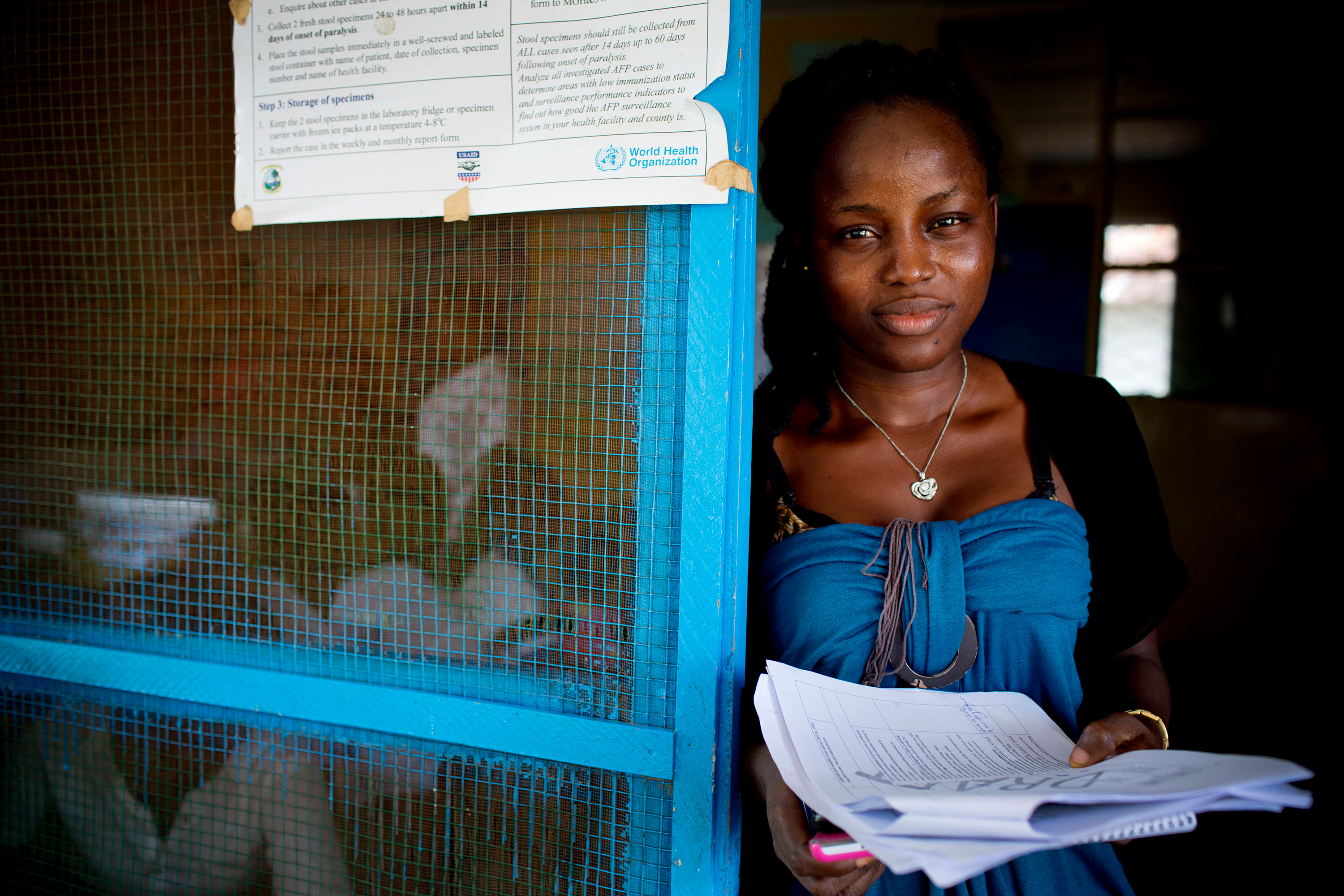 A woman standing at a door.