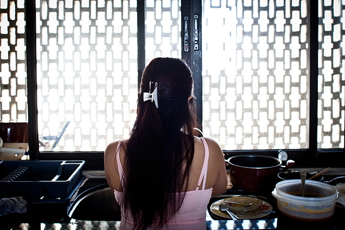 A woman standing in front of a window