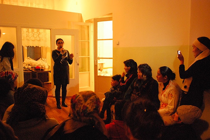 Woman singing in front a small group