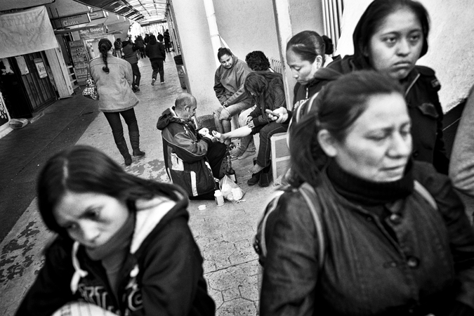 Women standing and tended to by person