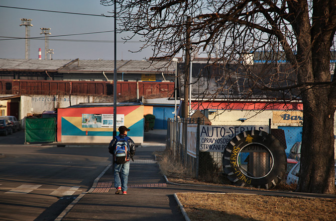 Child walking, wearing a backpack