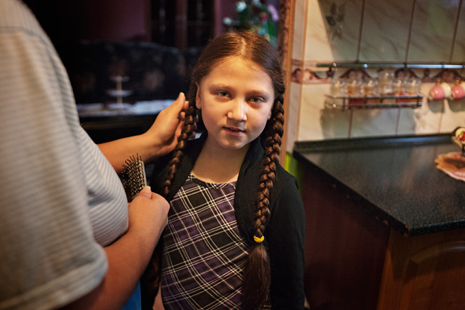 Girl getting her hair combed