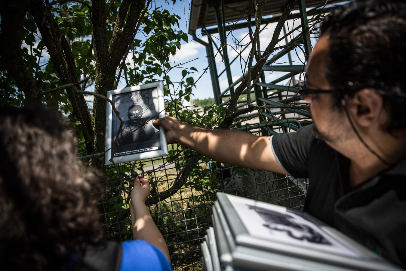 A man hanging a photo