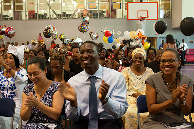 People seated and clapping.