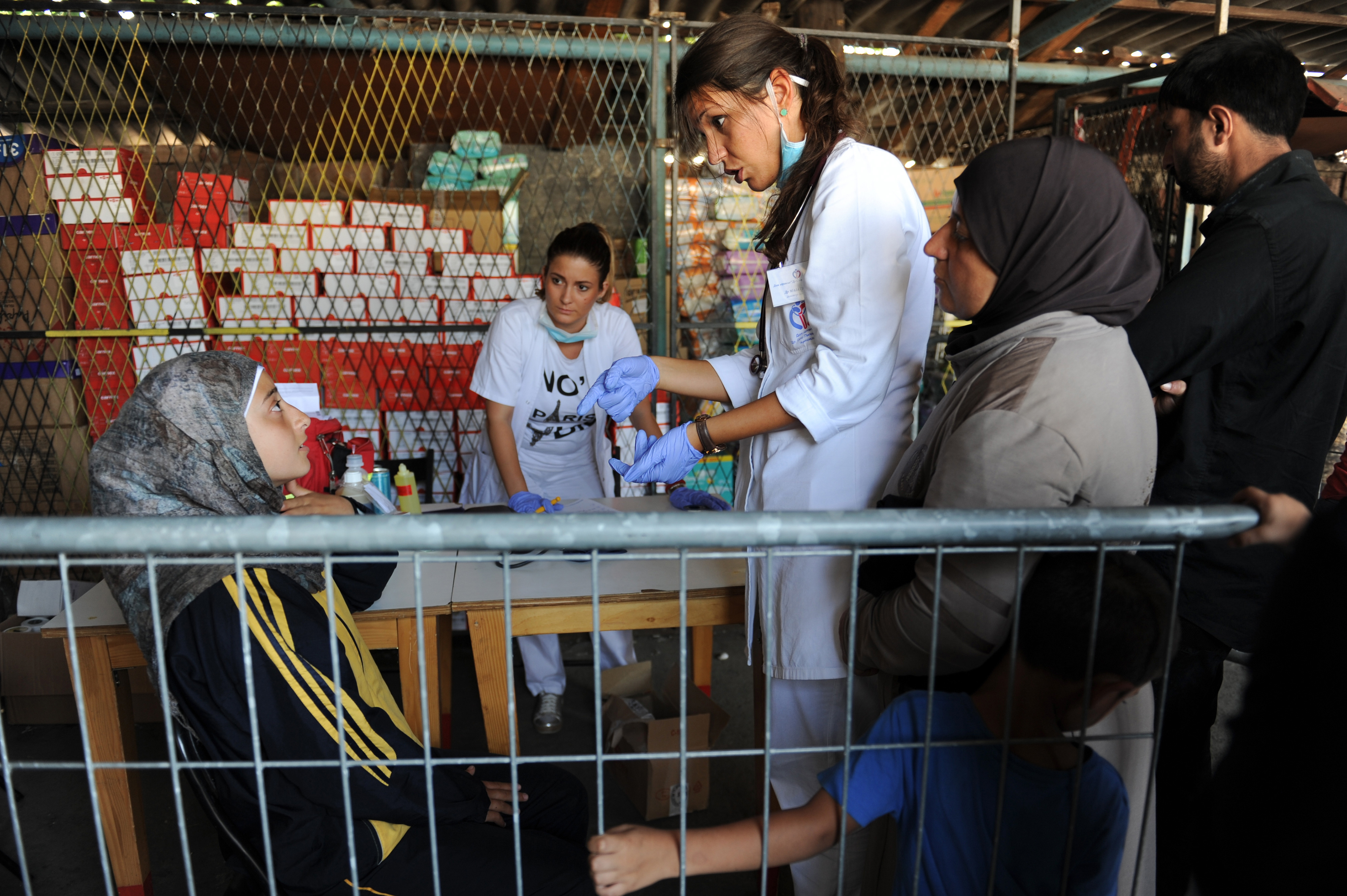 A girl speaks with a doctor at an ngo reception center