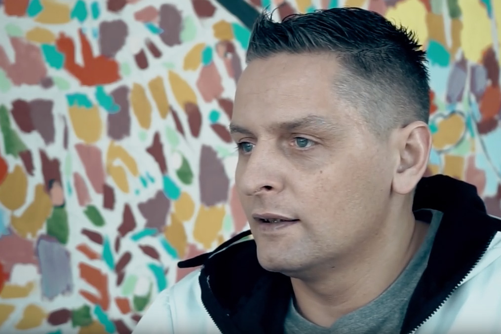 Maciej Dobrowolski by multi-colored wall