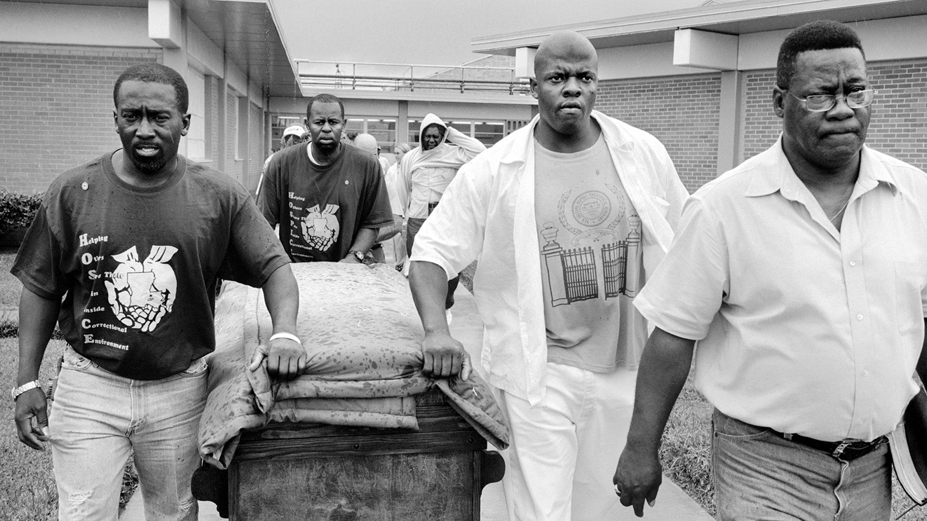 A group of men carry a coffin