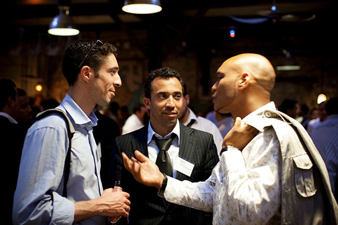 Professional men at networking event.