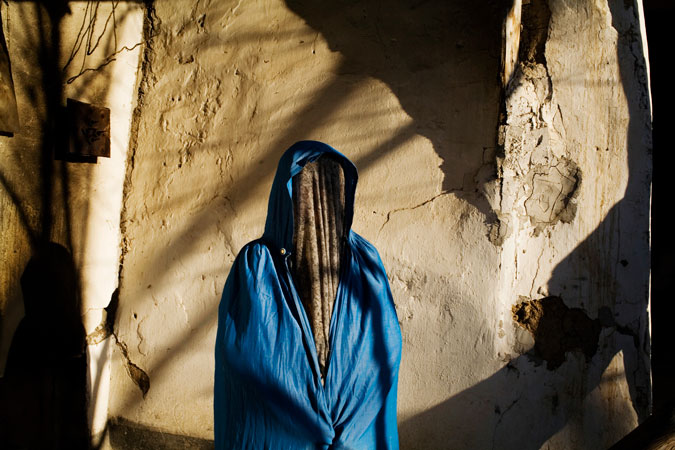 Woman poses in her courtyard.