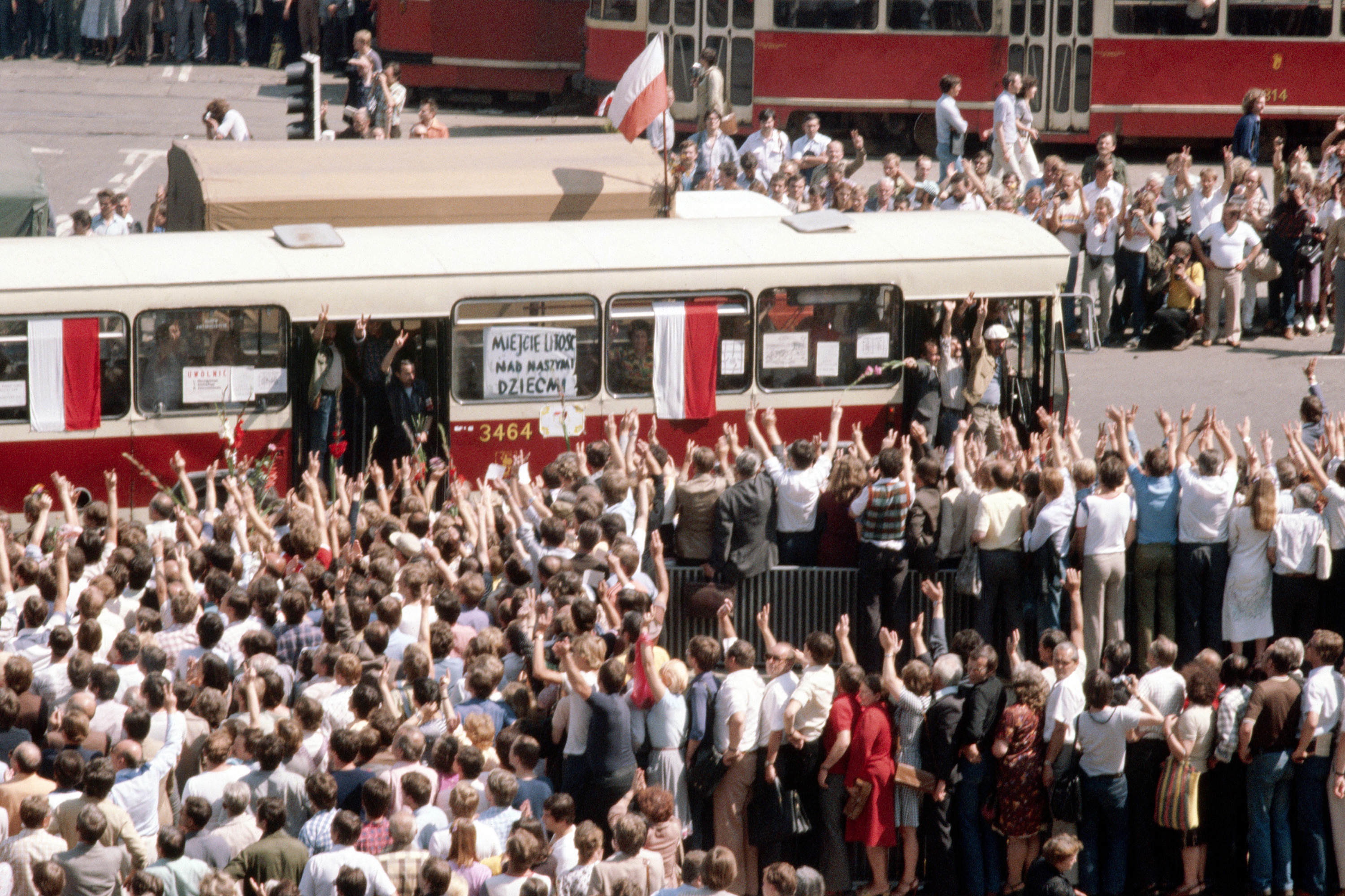 Crowds gather around a city bus