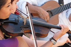 Musicians perform at the annual festival celebrating Saint Sarah in Saintes-Maries-de-la-Mer, France. Photo credit: Chuck Sudetic/Open Society Foundations Female violin players