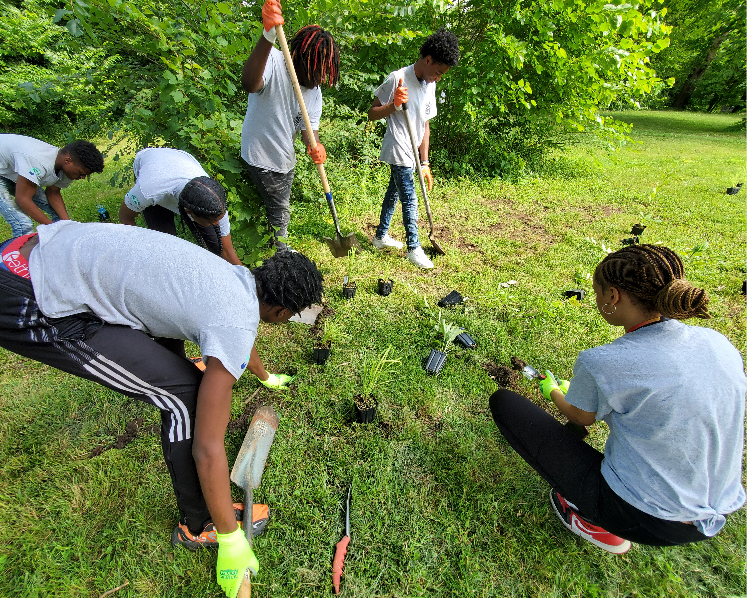 Neighborhood residents work in a community garden.