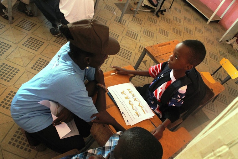 Woman and young boy in school room