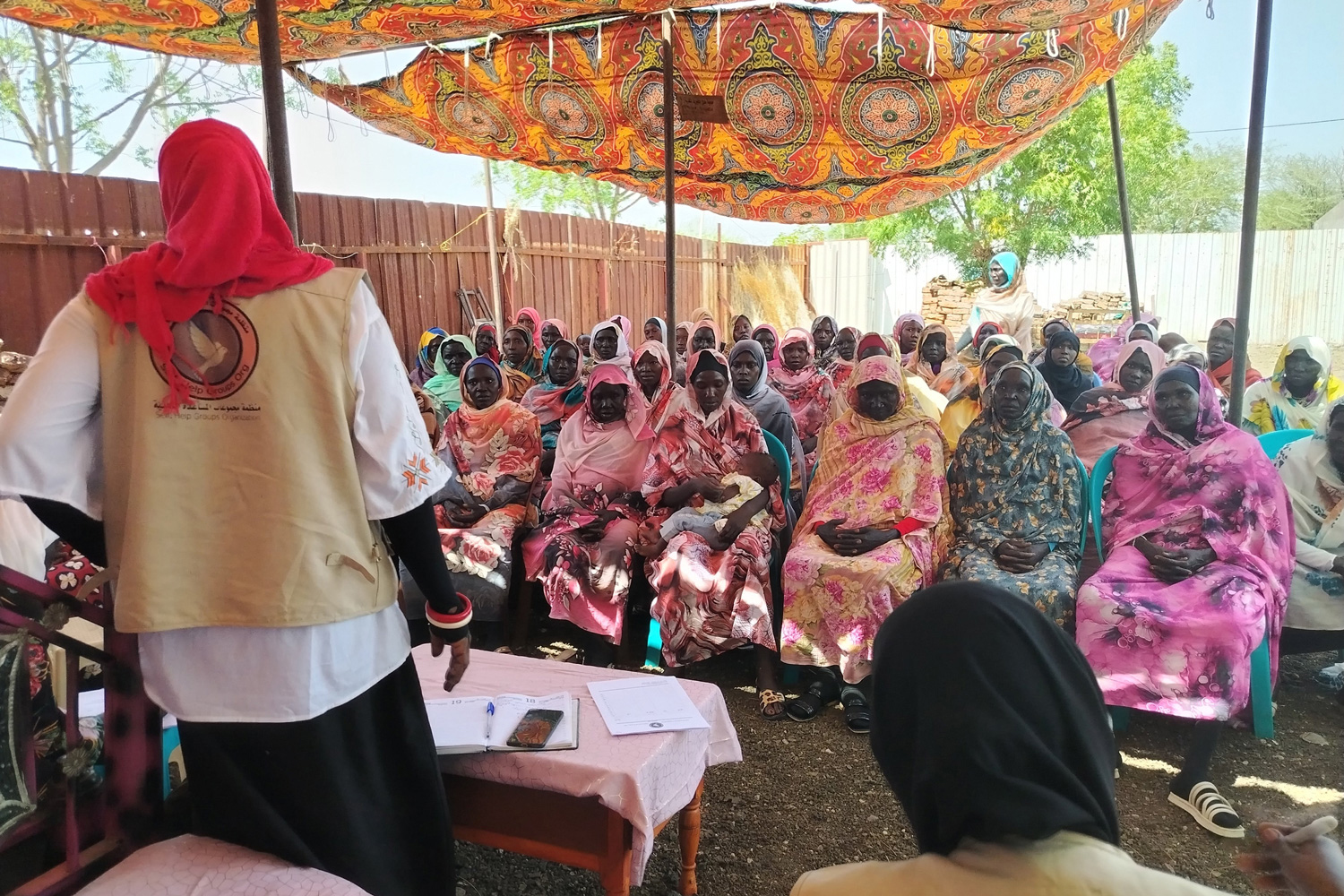 A group of women sitting as a group for a meeting