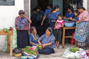 Women in traditional dress with radishes