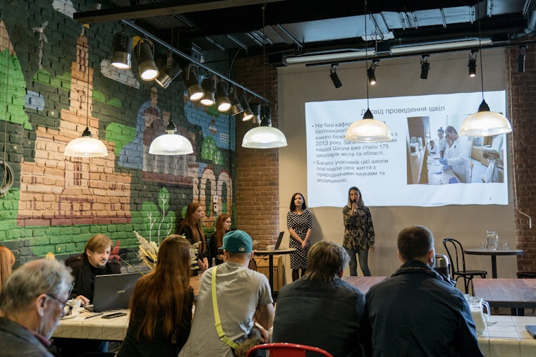 Grantees of Teple Misto present their project at Urban Space 100 in Ivano-Frankivsk, Ukraine, on October 17, 2019. Photo credit: © Andriy Sydoruk for Teple Misto Two people standing in front of a projected image on a wall