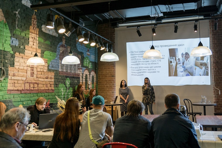 Two people standing in front of a projected image on a wall