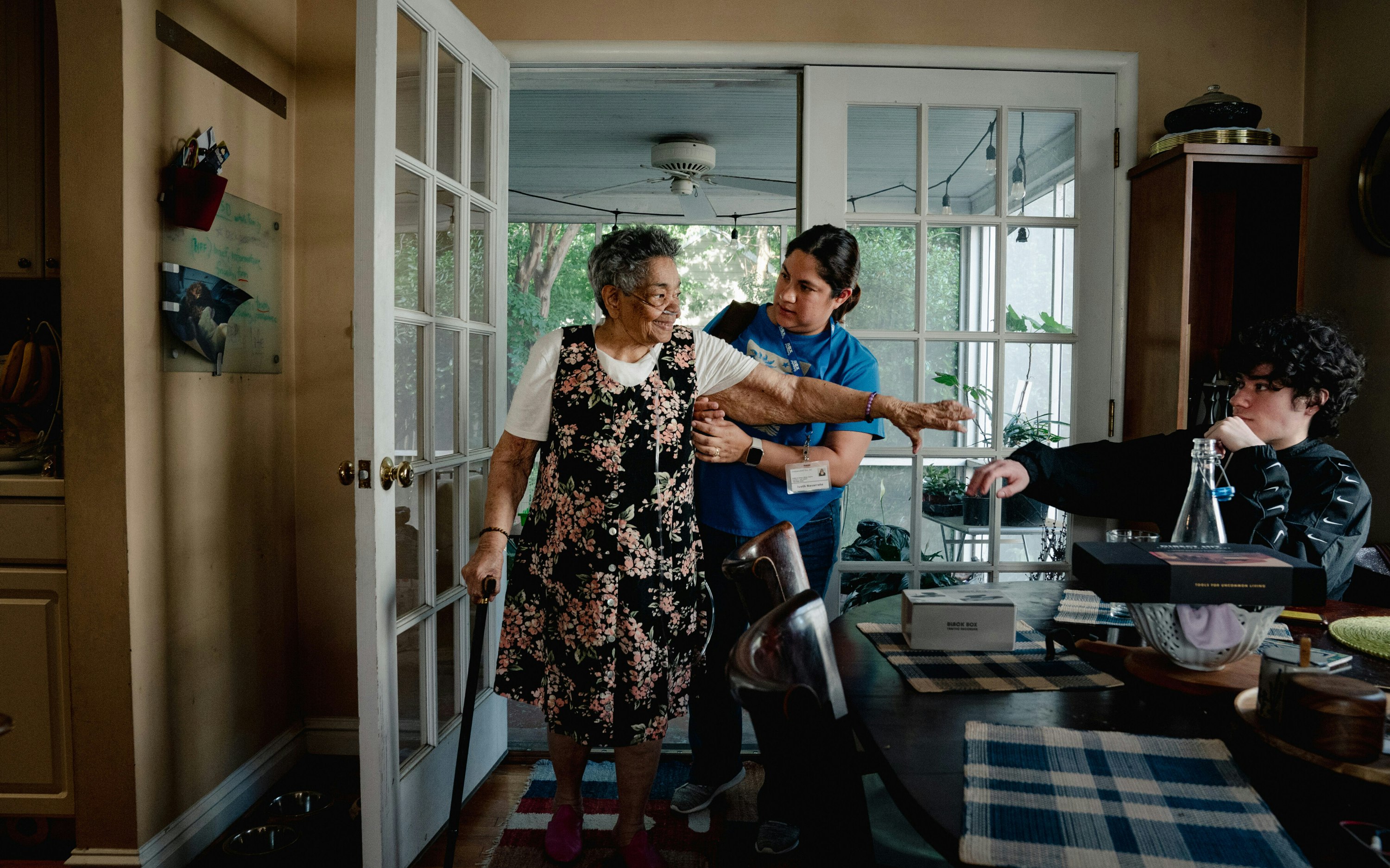 A grandmother reaches out to her grandson where she receives palliative home care in Arlington, Virginia, on June 26, 2024. © Shuran Huang/NYTimes/Redux A nurse helps an older woman with a walker
